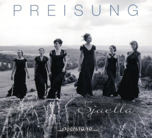 Five women in black dresses walk across a grassy field.