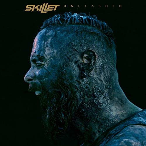 "Side profile of a bearded man covered in dark mud on album cover."