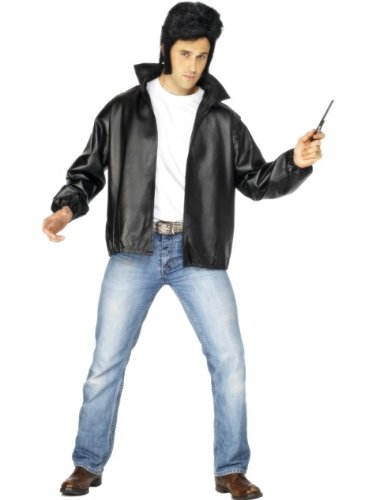 Man in black leather jacket, jeans, and styled hair, posing.