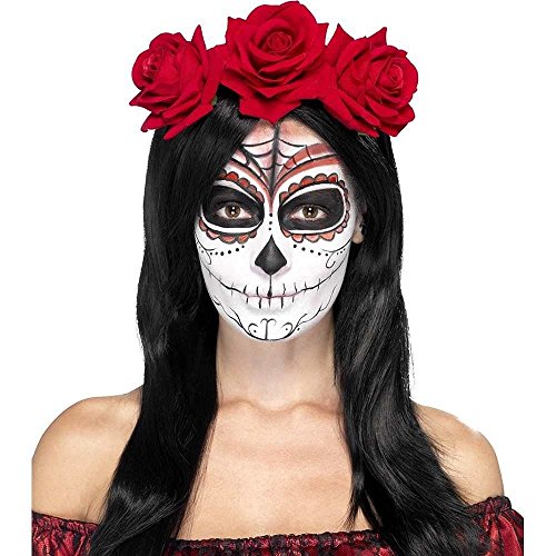 A woman with a sugar skull face paint and a red rose headband.