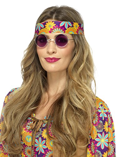 A woman wearing purple sunglasses, floral headband, and a matching floral-patterned shirt.