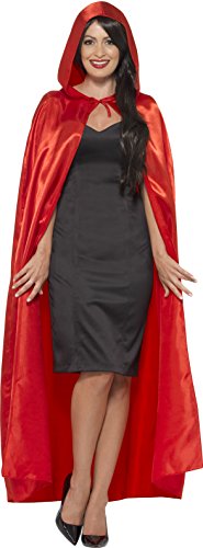 A red hooded cape worn over a black dress by a smiling woman.