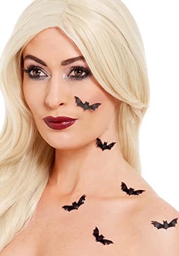 Woman with blonde hair and black bat face and neck stickers.