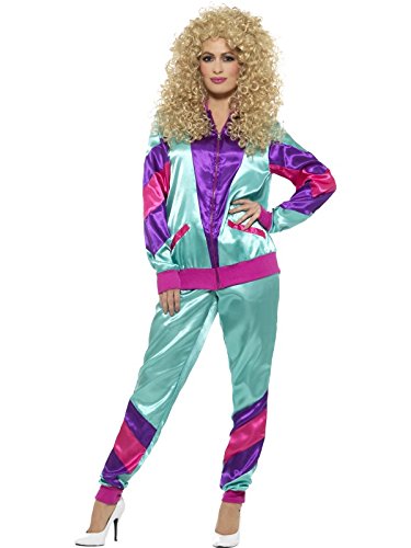 Woman wearing shiny 80s-style shell suit with curly blonde wig and white high heels.