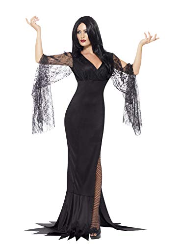 Woman in long black lace-sleeved gown, posing with arms outstretched.