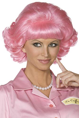 Pink, curly wig worn by a woman with a pearl necklace.