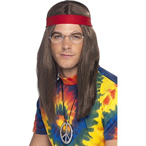 Man wearing hippie costume, including wig, glasses, red headband, tie-dye shirt, and peace sign necklace.