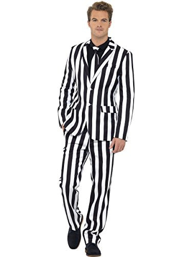 A man wearing a black and white vertical striped suit, shirt, and matching tie.