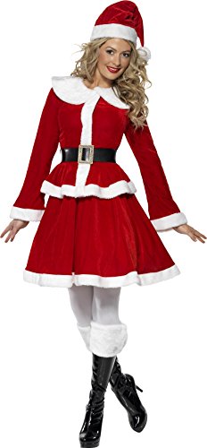 Woman wearing red and white Miss Santa costume, hat, and black boots, holding a white clutch.