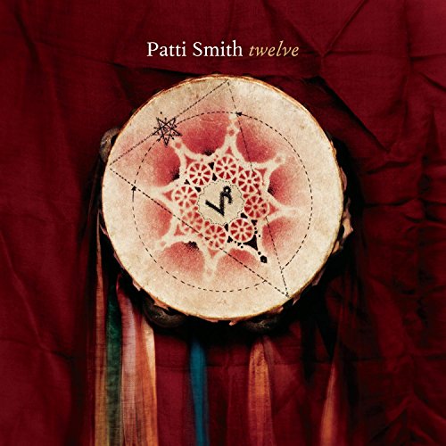 Patti Smith's "Twelve" album cover featuring a decorated drum against red fabric.