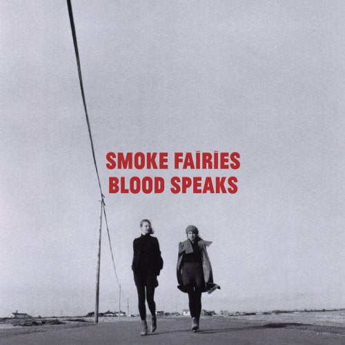 Black and white album cover with two women walking down a road.