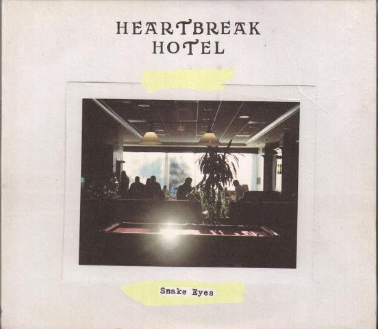 DVD cover for "Snake Eyes" showing a hotel lobby with people.