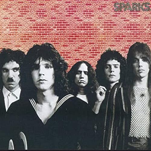 Sparks album cover featuring five men in front of a red brick wall.
