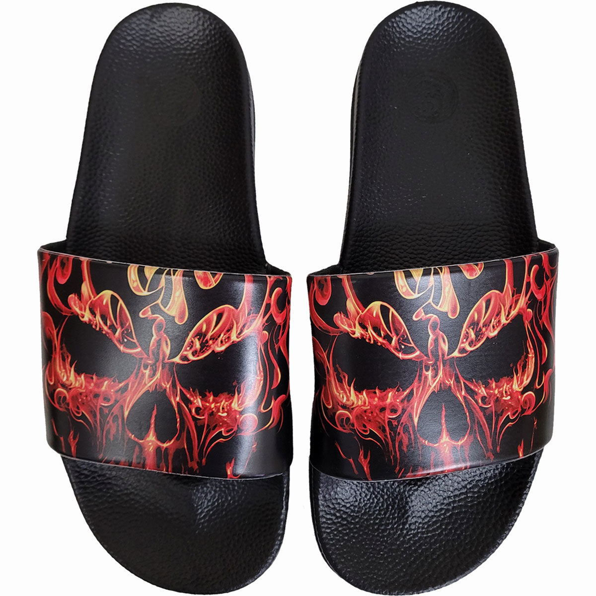 Black sandals with a fiery red and black skull graphic on straps.