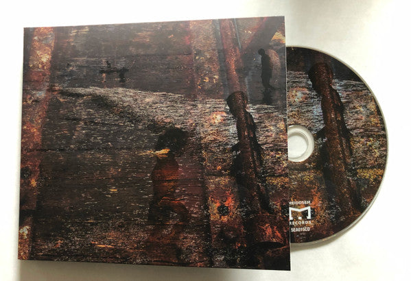 CD case and disc with dark, textured imagery of trees and figures.