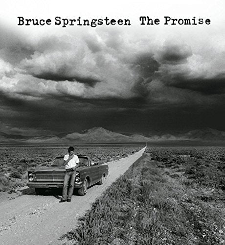 Black and white album cover featuring Bruce Springsteen by a car.