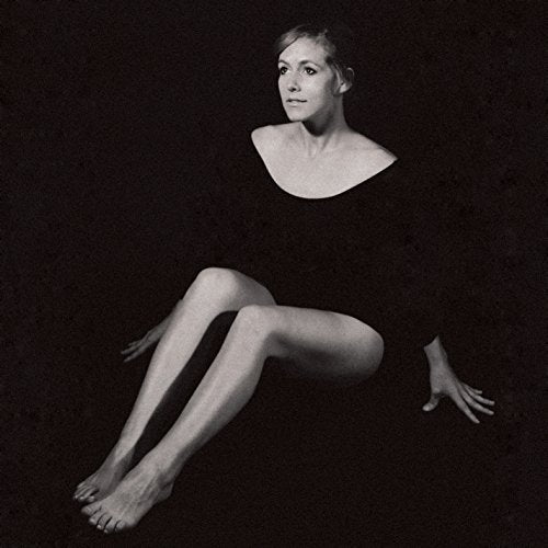 Black and white album cover featuring a woman seated with bare feet.