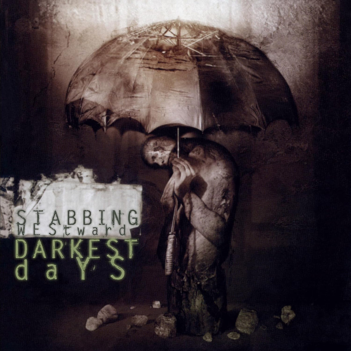 Figure with umbrella stands in rubble, album title “Stabbing Westward - Darkest Days”.