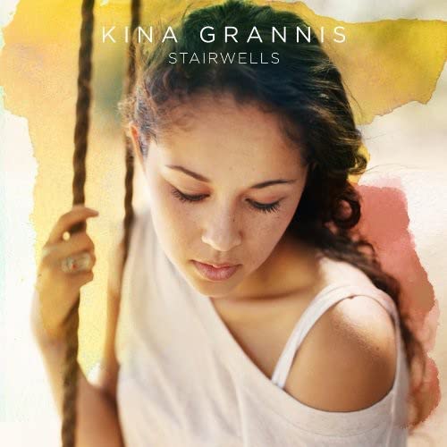 Kina Grannis album cover featuring a portrait of the artist against watercolor background textures.