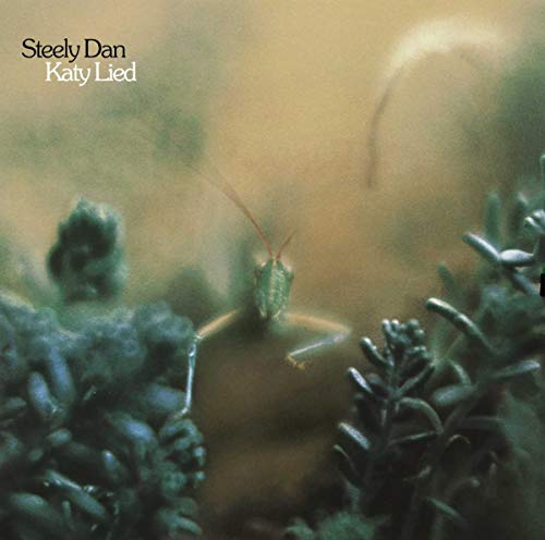 Steely Dan’s “Katy Lied” album cover featuring a green grasshopper in foliage.