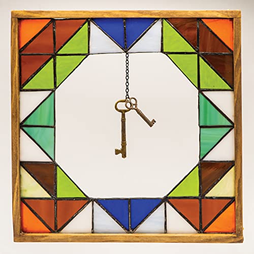 Stained glass frame with a hanging antique key in the center.
