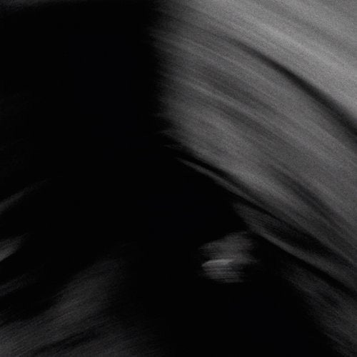 Abstract black and gray brushstrokes, suggesting a shadowed figure.