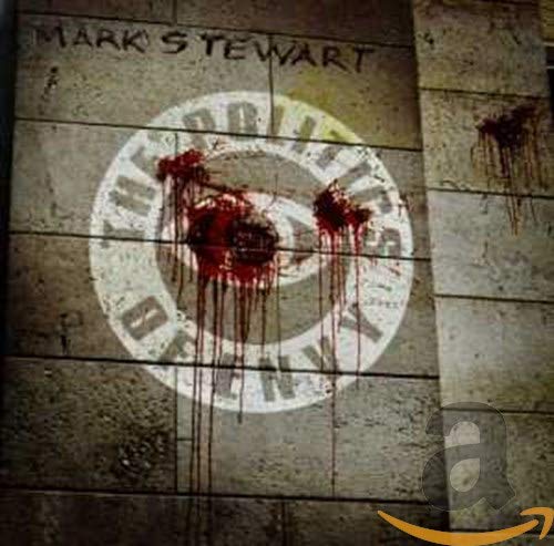 A grey brick wall with a bloody target and graffiti with an orange logo.