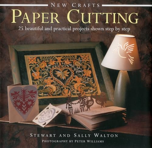Book cover featuring intricate paper cut designs, a lamp, and cards.