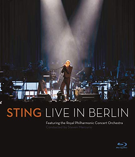 Sting performing on stage with an orchestra under a spotlight, titled Live in Berlin.