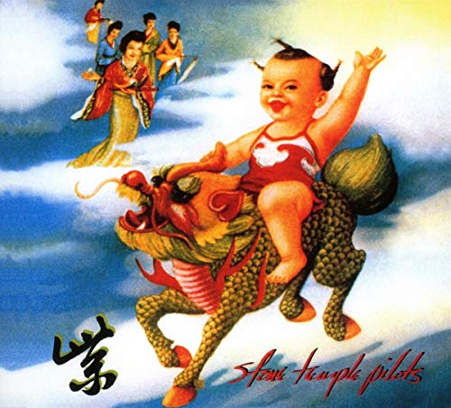 Baby riding dragon with people on surfboards in background, surrounded by clouds.