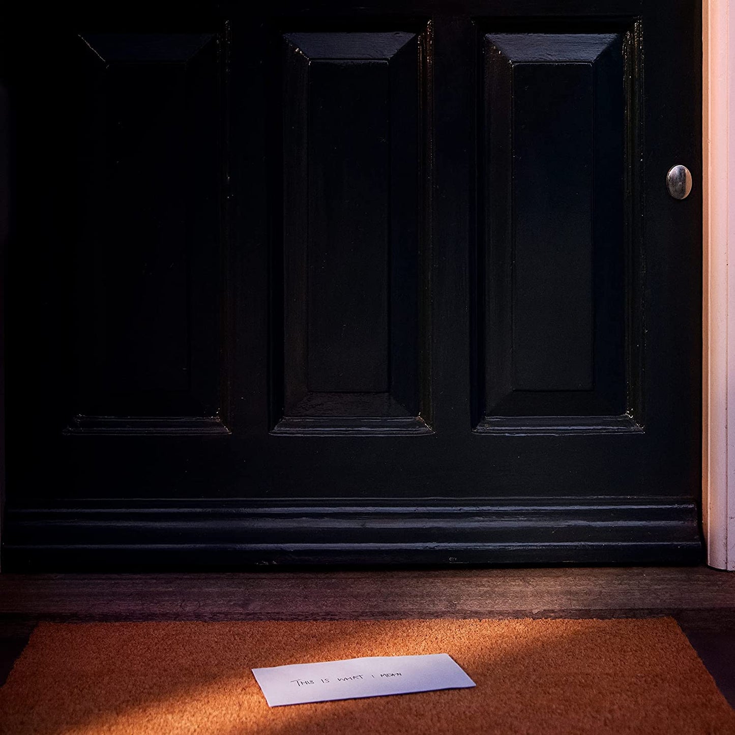 Stormzy CD album cover: black door with letter on doormat.