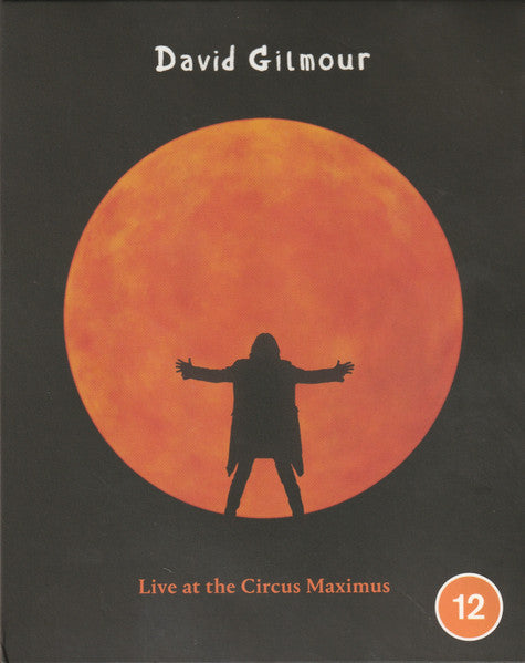 Blu-ray cover: Silhouette of a man before a large orange sun.