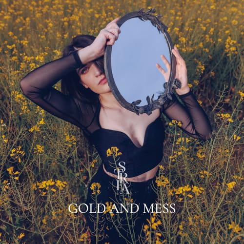 Woman holding ornate mirror in a field of yellow flowers.
