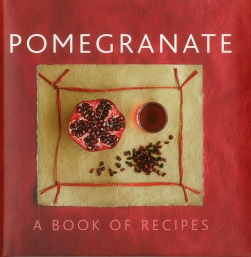 Book cover titled Pomegranate featuring a halved pomegranate, seeds, and juice on parchment paper.