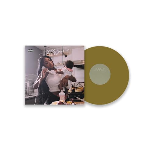 Summer Walker's "Still Over It" vinyl record with album cover and gold disc.