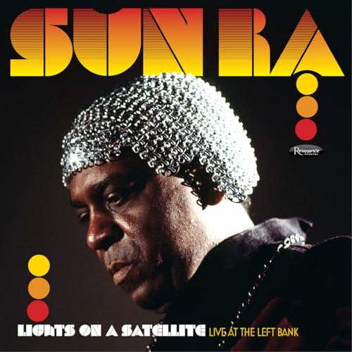 Sun Ra portrait with silver headpiece, album title "Lights On A Satellite".
