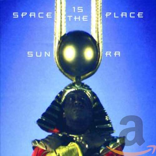 Sun Ra wearing an Egyptian-style headdress with a glowing orb against a blue background.