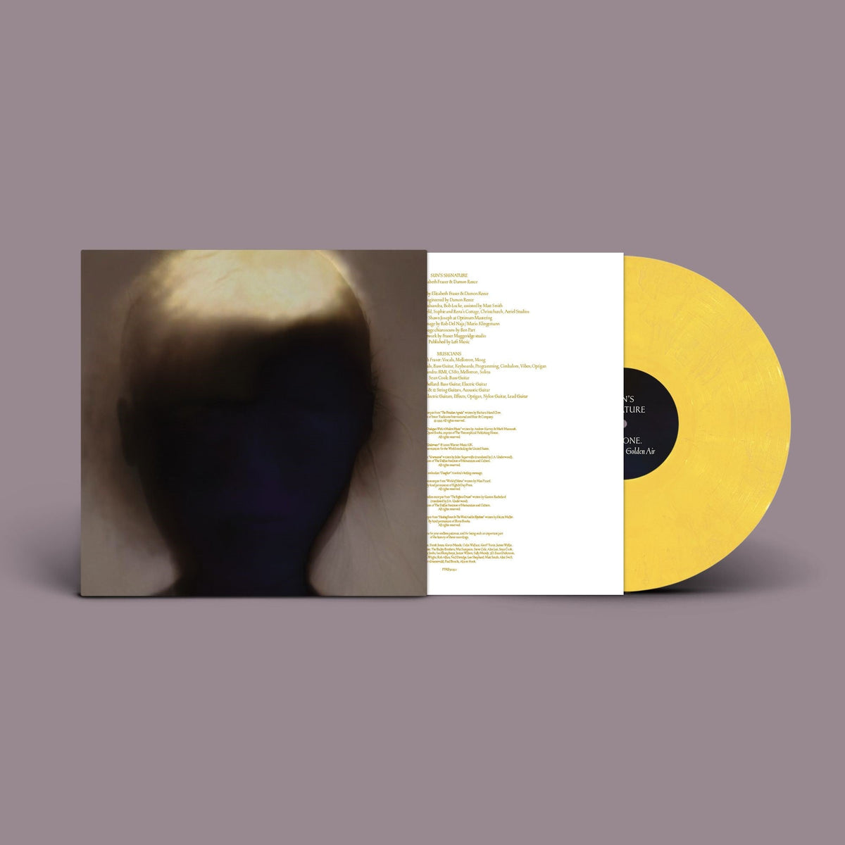 Yellow vinyl record with album artwork featuring a blurred face and text.