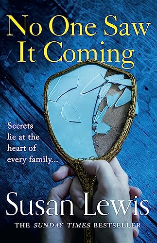 Book cover: broken mirror held by a hand, dark blue background.