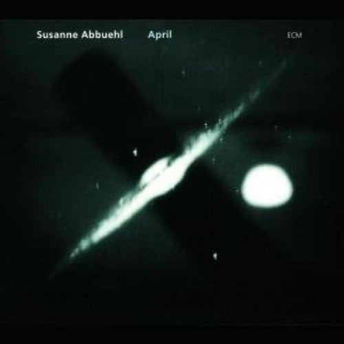 "Album cover with black background, white streak, and circle, featuring artist and title."