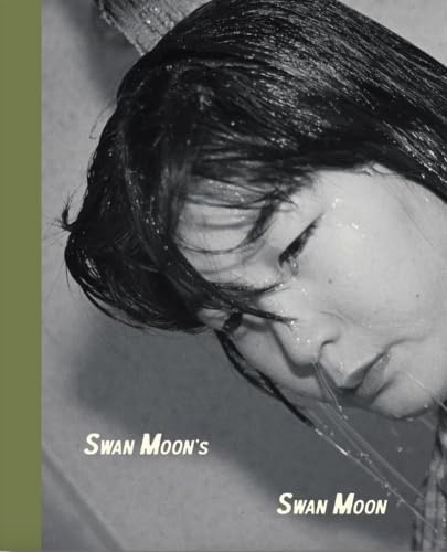 Close-up of a person with wet hair and the book title "Swan Moon.