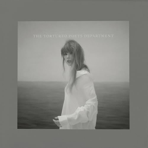 Taylor Swift in a white shirt standing by the sea, album title text above.