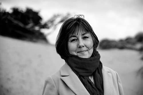 Black and white portrait of a woman with short hair and a scarf.