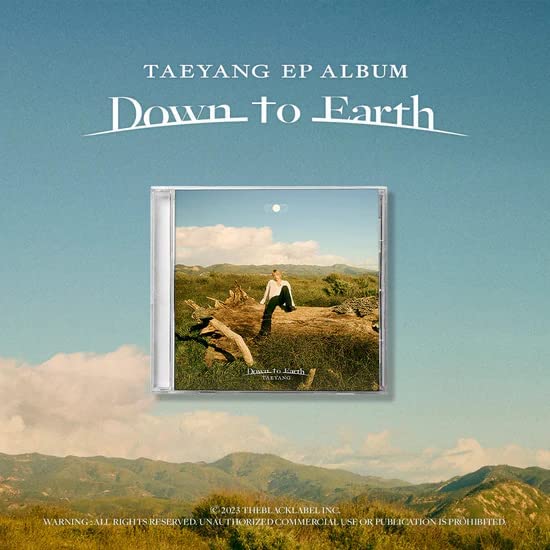 Taeyang’s “Down to Earth” CD album cover with a landscape scene.