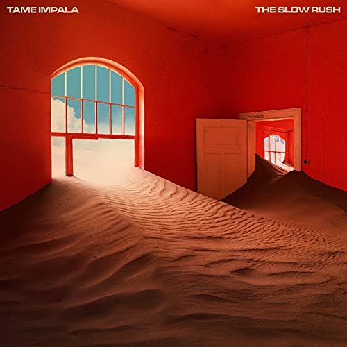 Sand dunes filling a red room with arched windows and an open door.