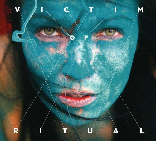 CD cover: Blue-toned face with geometric lines and text "VICTIM OF RITUAL".