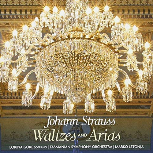 A large, glowing crystal chandelier hangs from an ornate ceiling on a CD cover.