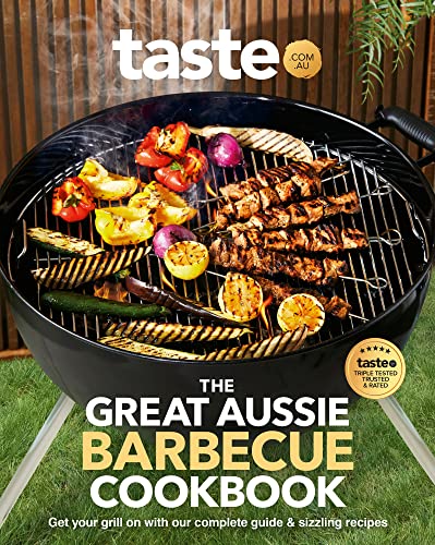 Cookbook cover featuring grilled meat and vegetables on a barbecue.