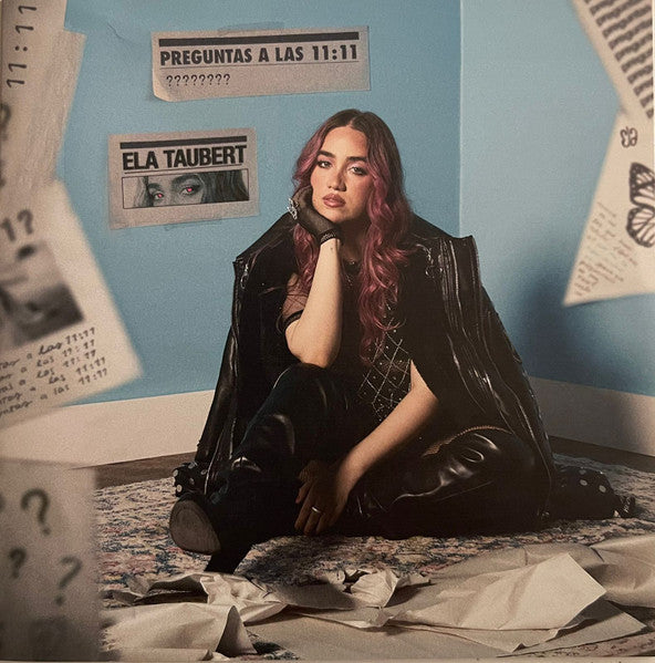 CD cover for Taubert Ela’s “Preguntas A Las 11:11”, featuring a seated woman.