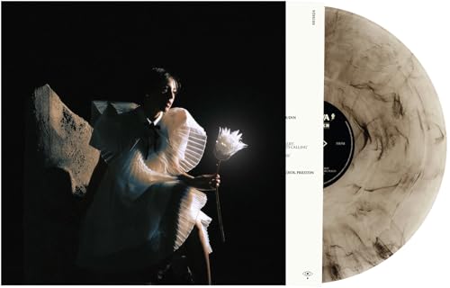 Vinyl record with album cover featuring a person in white clothing.